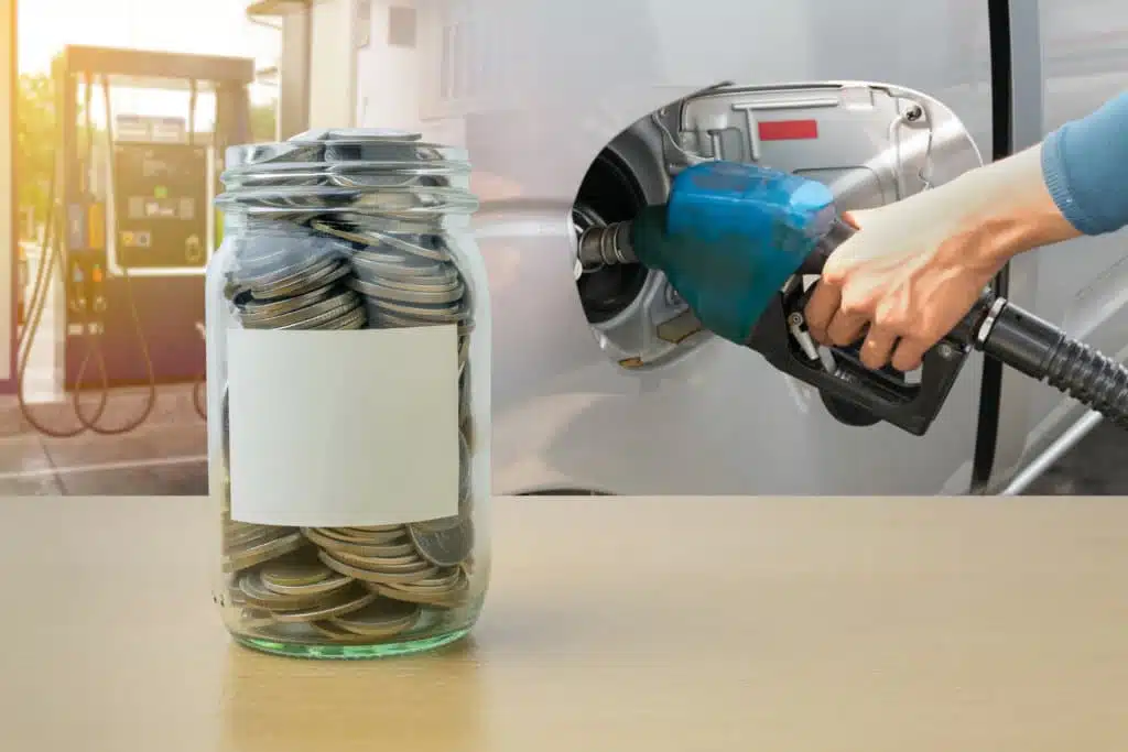 Jar of coins next to gas pump in car