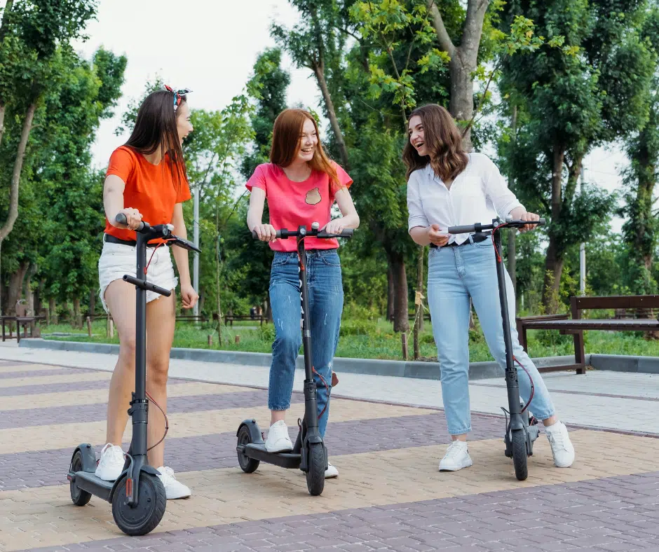 3 girls riding 3 electric scooters