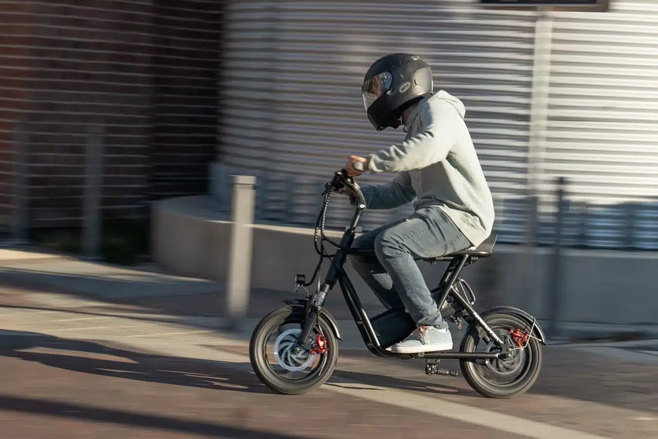 man riding the emove roadrunner seated electric scooter on the street