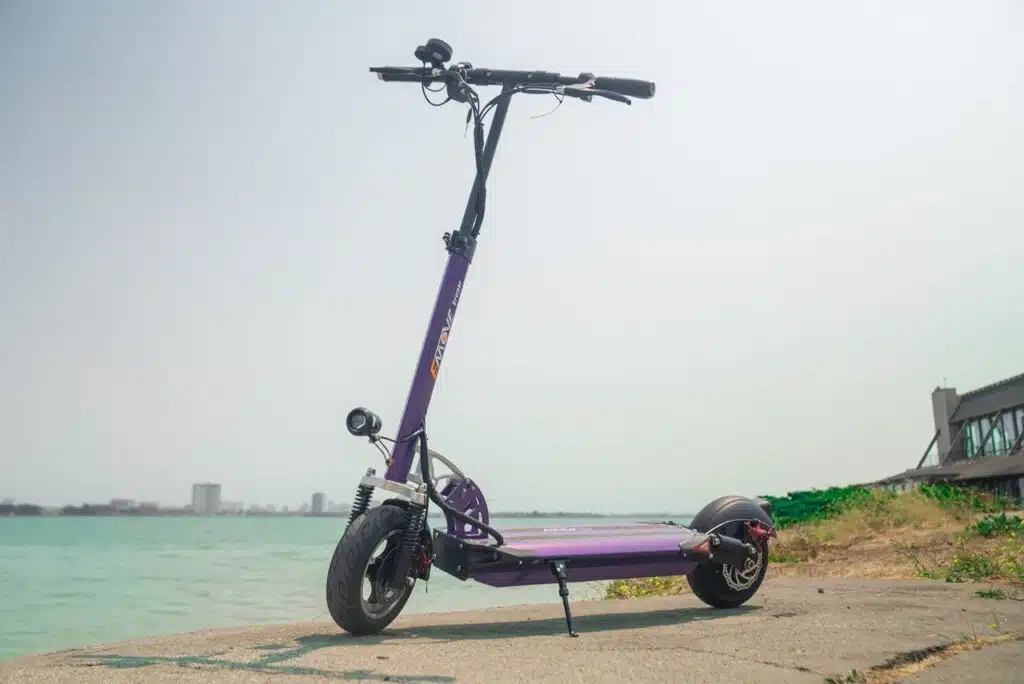 Purple EMOVE Cruiser 2021 in front of cyan river