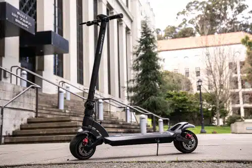 Mercane-Widewheel-Pro-electric-scooter-full-scooter-stem-to-left-top-angle-building-in-background