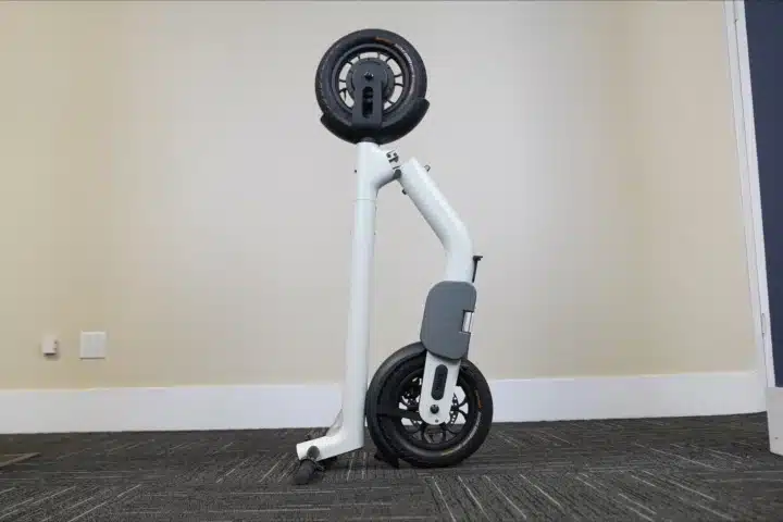 taur electric scooter standing folded on carpet