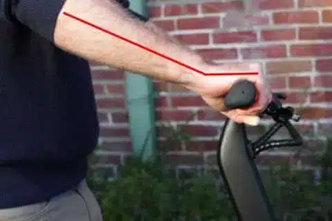 Man demonstrating bad wrist position on an electric scooter twist throttle