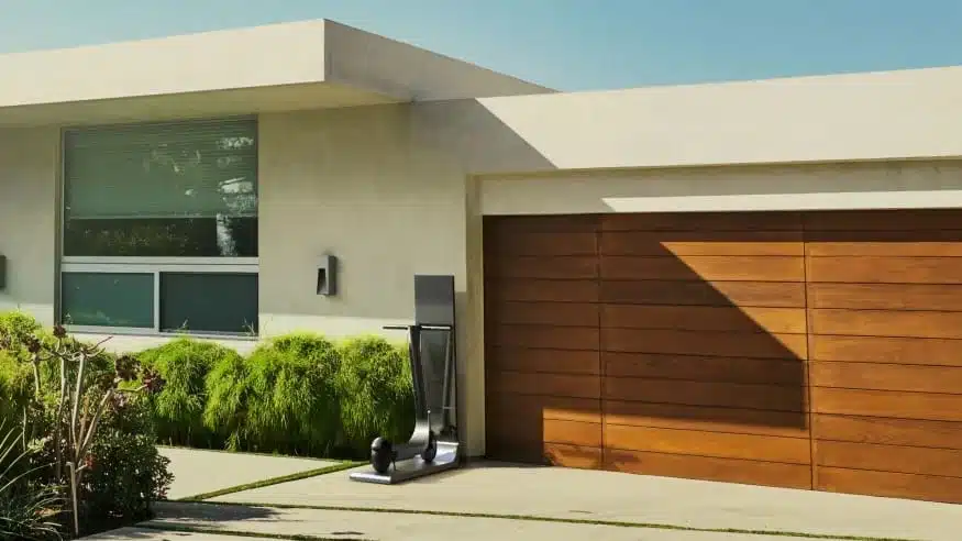 modern home with electric scooter charging in front of it