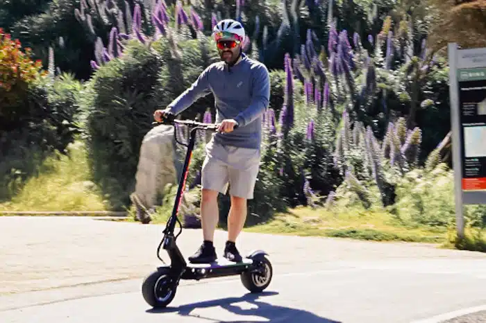 Dualtron Thunder ridden in front of flowering forest