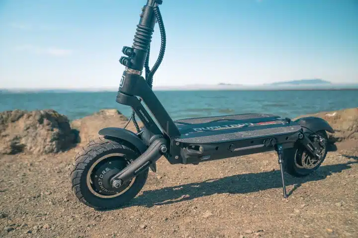 Dualtron Victor deck on gravel in front of river