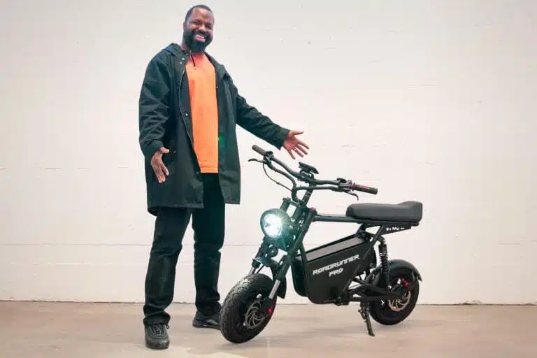 man standing next to Emove roadrunner Pro