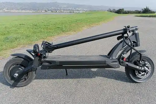kaabo mantis pro electric scooter folded by a field