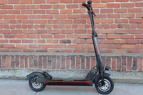 kaabo skywalker 10s full scooter in front of brick wall