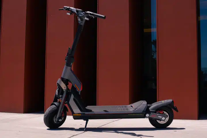 portrait of Black Segway GT2 in front of red Pillared building