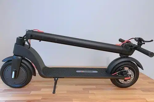 turboant x7 electric scooter folded on a wood floor