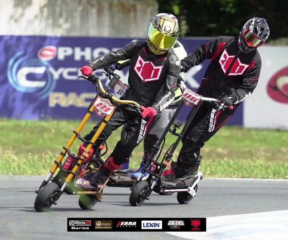 two people racing kaabo electric scooters wearing kaabo gear