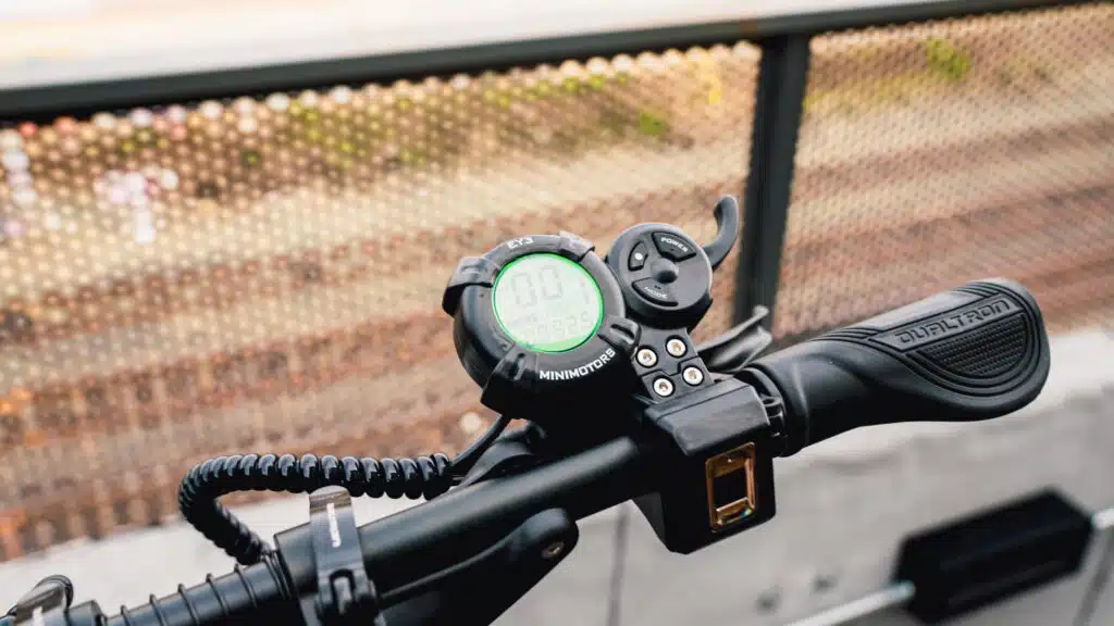 The throttle, display, and right handgrip of the Dualtron Storm Limited electric scooter