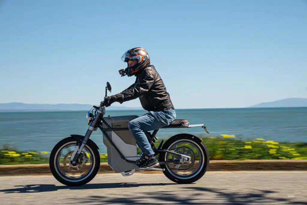 Man riding the Land Moto District electric motorcycle