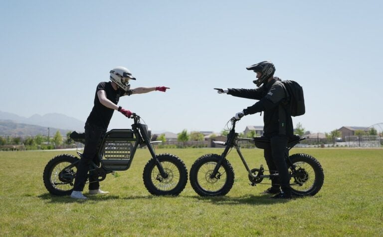 two riders on the Ride1Up REVV1 DRT ebike and the Super73-Z Adventure Series ebike point at each other