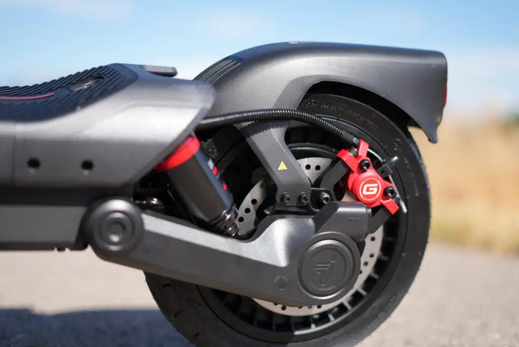Segway MAX G3 Plus First Impressions: They Really Surprised Us 3 Rear disc brake, red caliper, and rear suspension linkage on the Segway MAX G3 Plus
