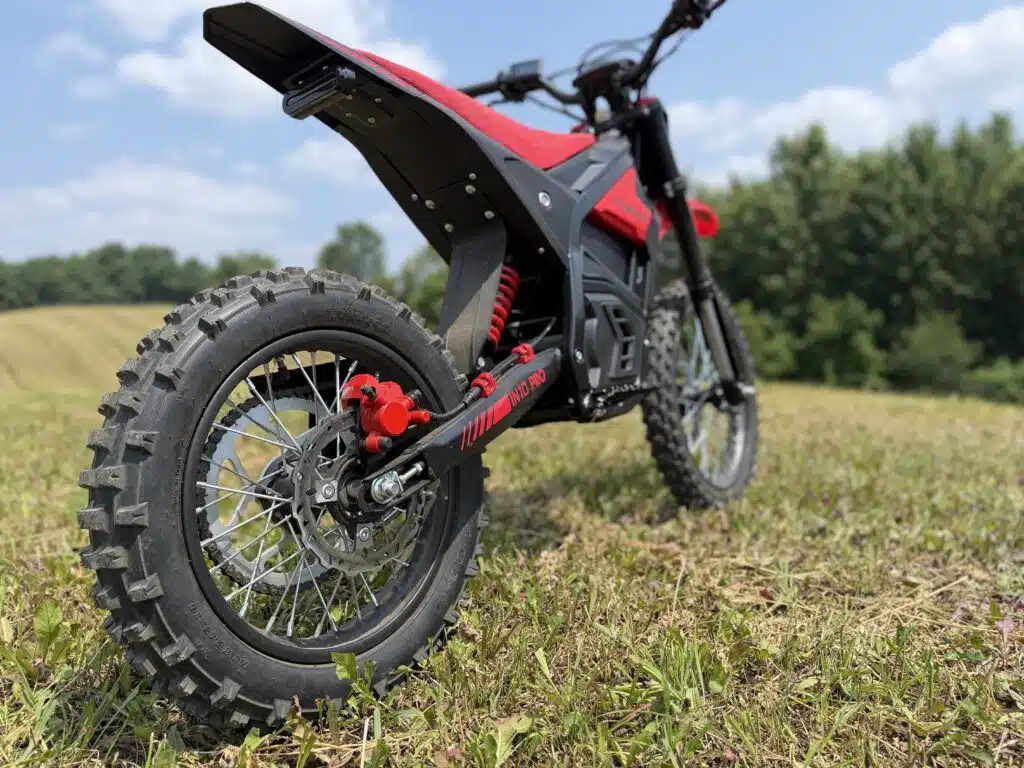 Yozma IN10 Pro Review: Is This $2,000 E-Dirt Bike a Real Sur Ron Killer? 3 Yozma IN10 Pro rear three-quarter view showing the 14-inch rear wheel