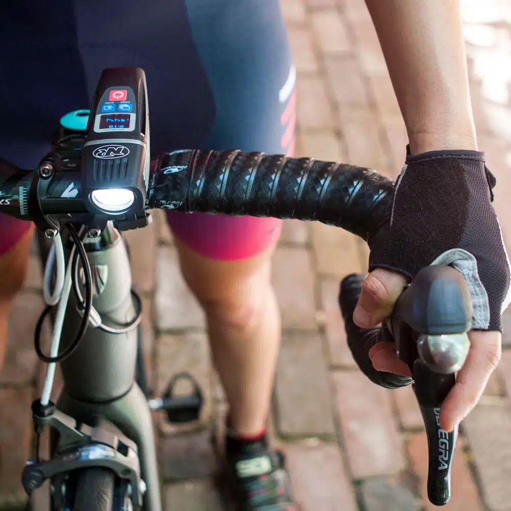 The 5 Best eBike Lights on Amazon Now That It Gets Dark at 6 3 NiteRider Lumina OLED 1200 Boost headlight with its runtime screen on a road bike handlebar
