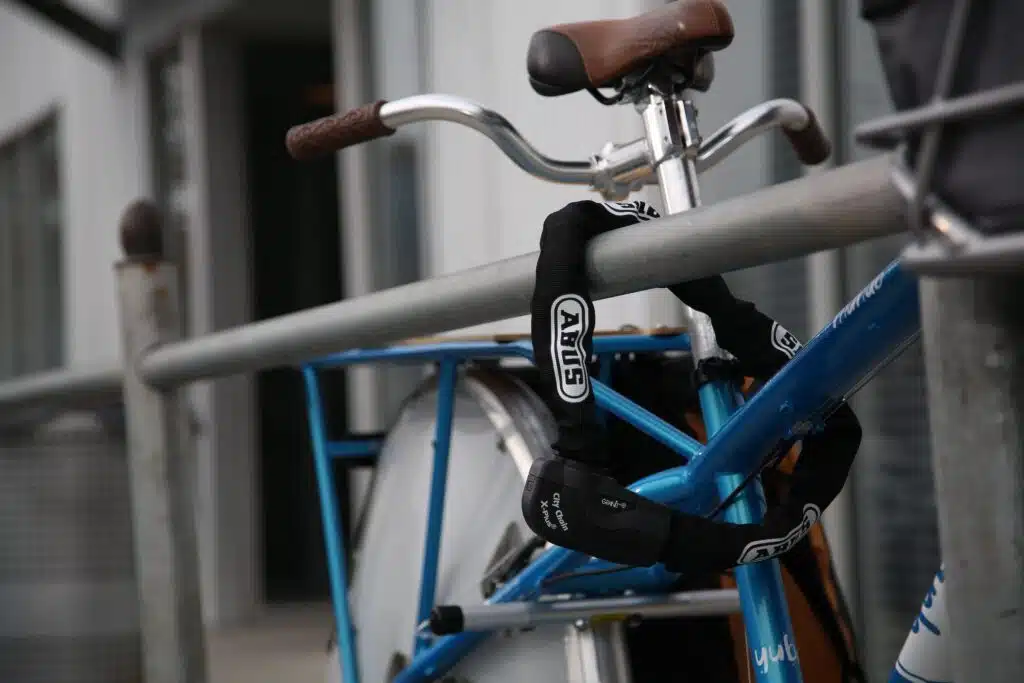 The 5 Best eBike Locks on Amazon (Thieves Hate These) 6 ABUS Granit CityChain XPlus 1060 chain lock securing a bike