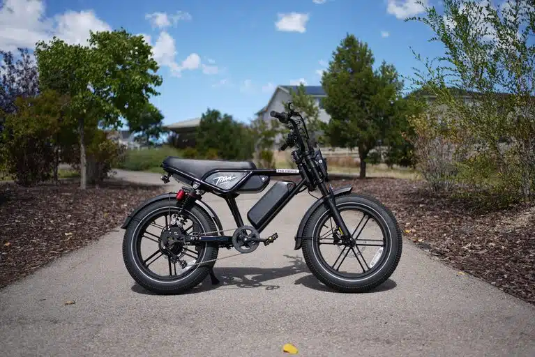 Heybike Titan moped-style electric bike, side view on a paved path, RiderGuide test bike