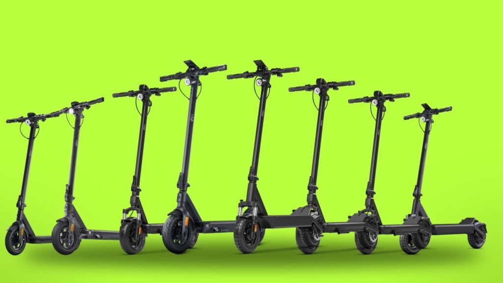 Eight VMAX electric scooters lined up, the models sold in the VMAX open-box and refurb store